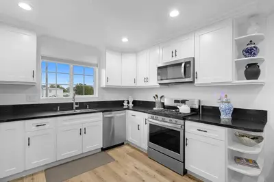 a white kitchen with white cabinets and a microwave at Casa Lanzit - 35 Percent Off All March! in Los Angeles