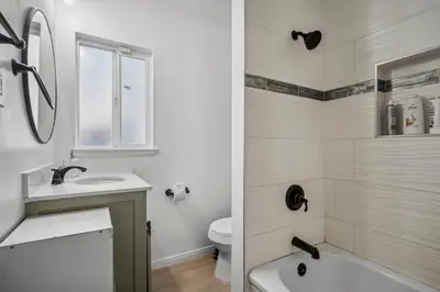 a white bathroom with a sink and a toilet at Cozy single story 2 bdrm family home near the BLVD in Lancaster