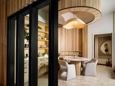 a kitchen with a table and chairs and a light fixture at Sanctity Hotel Rancho Cucamonga, Tapestry Collection Hilton in Rancho Cucamonga