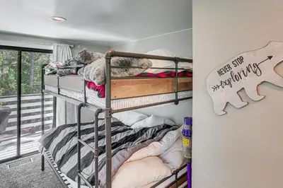 a bedroom with two bunk beds in a room at Lake Arrowhead Cabin with Hot Tub and Mountain Views! in Lake Arrowhead