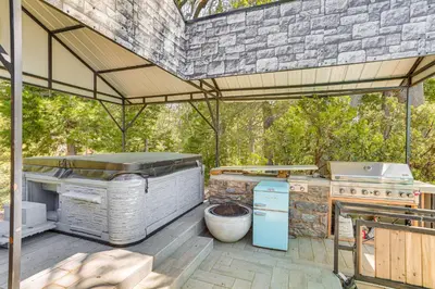 an outdoor kitchen with a large grill and a grill at Lake Arrowhead Cabin with Hot Tub and Mountain Views! in Lake Arrowhead