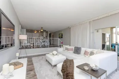 a living room with a white couch and a table at OCEAN PARADISE SANTA MONICA ADJACENT 2 Bedroom in Malibu
