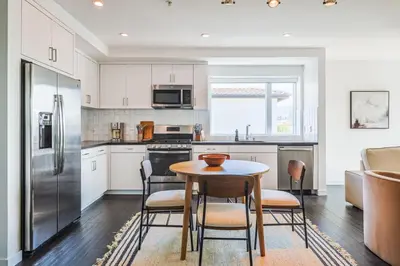 a kitchen with a table and chairs and a refrigerator at Luxurious 2Bed 2Bath Apartment at Formosa in Los Angeles
