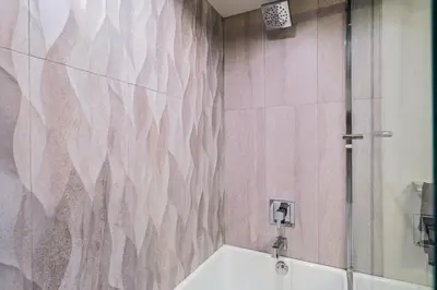 a bathroom with a shower and a tub and a sink at Luxurious 2Bed 2Bath Apartment at Formosa in Los Angeles