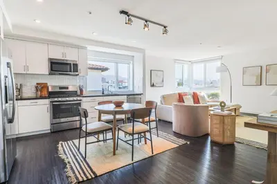 a kitchen and living room with a table and chairs at Luxurious 2Bed 2Bath Apartment at Formosa in Los Angeles