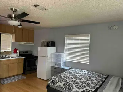 a kitchen with a bed and a white refrigerator at Private Studio GuestHouse With Everything! in Los Angeles