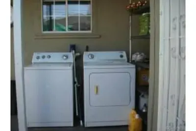 a kitchen with two white appliances and a window at Private Studio GuestHouse With Everything! in Los Angeles