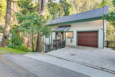a house with a garage and a driveway at Crestline Home with Deck Less Than 2 Mi to Lake Gregory! in Crestline