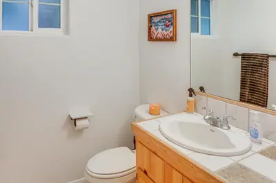 a bathroom with a white toilet and a sink at Crestline Home with Deck Less Than 2 Mi to Lake Gregory! in Crestline