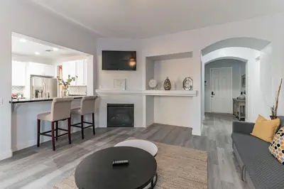 a living room with a couch and a table at Modern 4BR Oasis, Fireplace, Patio & Spacious Family Room in Palmdale