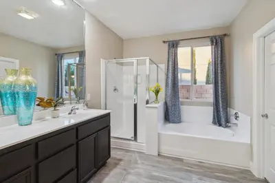 a bathroom with two sinks and a shower and a tub at Modern 4BR Oasis, Fireplace, Patio & Spacious Family Room in Palmdale
