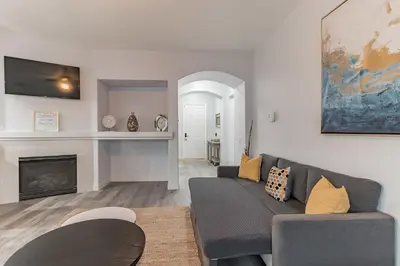 a living room with a couch and a fireplace at Modern 4BR Oasis, Fireplace, Patio & Spacious Family Room in Palmdale