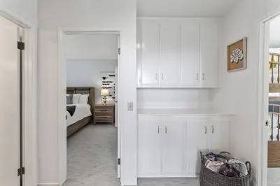 a bedroom with white cabinets and a bed in a room at Luxe Mountain Retreat Lake Village Close Game Room AC Backs up to trails in Lake Arrowhead