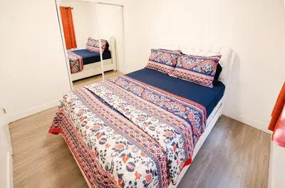 a small bedroom with a bed and a mirror at Cozy 2 Bedroom 1 Bathroom Apartment Ideal for Small Group in Koreatown Free Gated Parking Full Kitch in Los Angeles
