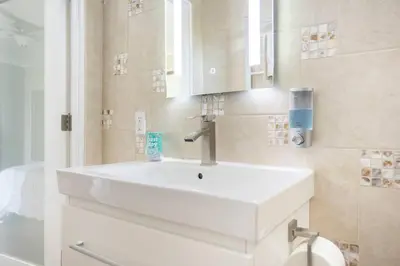 a bathroom with a white sink and a mirror at Bedroom Suite with Private Entrance in Los Angeles