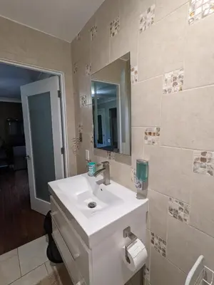 a bathroom with a white sink and a mirror at Bedroom Suite with Private Entrance in Los Angeles