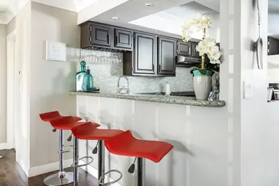 a kitchen with red stools in front of a counter at Bedroom Suite with Private Entrance in Los Angeles
