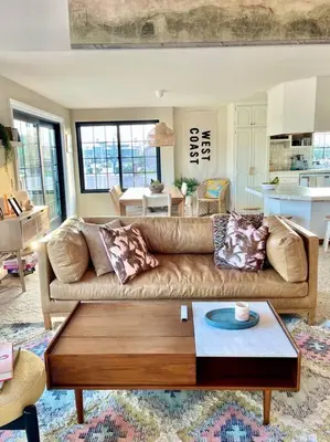 a living room with a couch and a coffee table at Cool Cali Vibe - Barefoot Stepping Distance 2 Sand in Oxnard