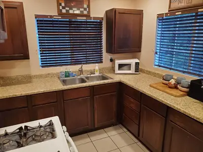 a kitchen with a sink and a microwave at The Treetop Terrace at The Historic Arrowhead Lodge in Twin Peaks