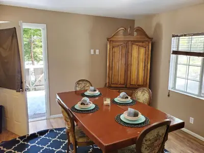 a dining room with a wooden table and chairs at The Treetop Terrace at The Historic Arrowhead Lodge in Twin Peaks