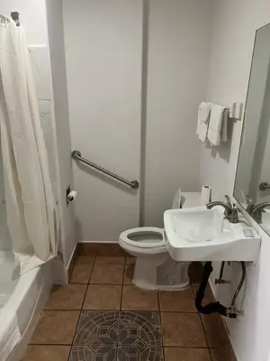 a bathroom with a toilet and a sink at King Motel in Los Angeles