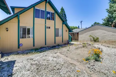 a house with a garden in front of it at Frazier Park Cabin with Ping-Pong Table, Near Trails in Frazier Park