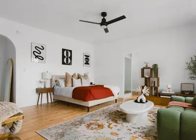 a living room with a bed and a couch at The Nirvana Apartment Hotel in Los Angeles