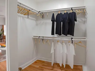 a dressing room with a rack of clothes at The Nirvana Apartment Hotel in Los Angeles