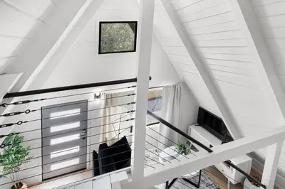 a staircase in a house with a window at Lake Isabella A frames in Lake Isabella