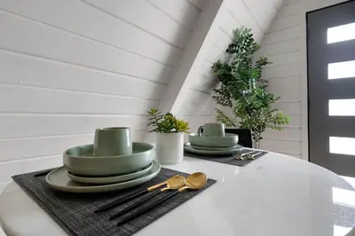 a table with two green plates and spoons on it at Lake Isabella A frames in Lake Isabella