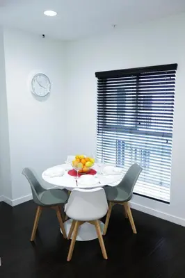 a table with chairs and a bowl of fruit on it at Downtown Cosmopolitan Residences in Los Angeles