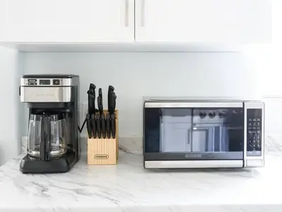 a kitchen counter with a coffee maker and a microwave at Family Renovated Home, Netflix, AC, WD, Putt Putt in Fullerton