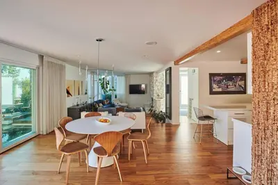 a kitchen and living room with a table and chairs at Luxe in Hollywood Hills- modern oasis, pool 5 min to Sunset in Los Angeles