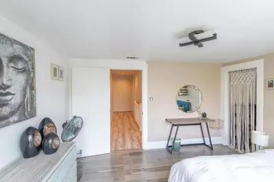 a bedroom with a bed and a table and a mirror at Oasis Hollywood in Los Angeles
