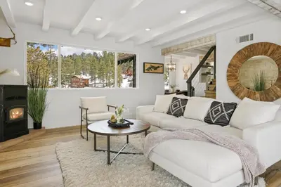 a living room with a couch and a table at Luxe Lakefront with Hot Tub, Fire Pit, Game Room, Boat Dock in Big Bear Lake