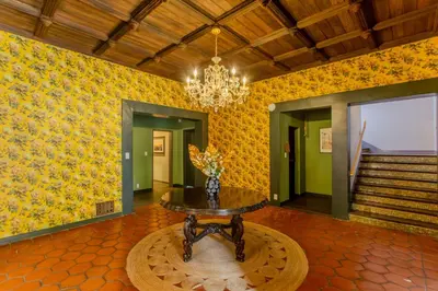 a dining room with a table and a chandelier at Westholme Park - Female Only in Los Angeles