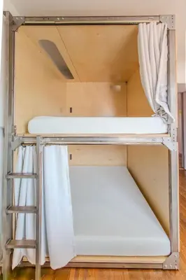 a bunk bed in a room with a ladder at Westholme Park - Female Only in Los Angeles