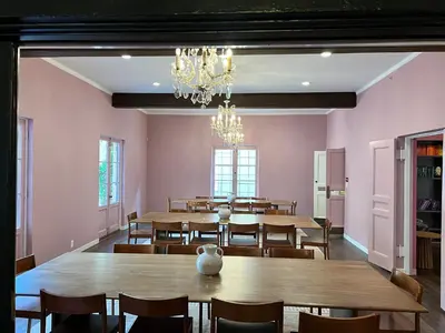 a dining room with tables and chairs and a chandelier at Westholme Park - Female Only in Los Angeles