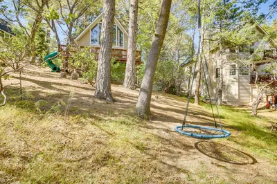 a playground in the yard of a house at Chic Lake Arrowhead Retreat 4 Seasons of Fun! in Lake Arrowhead