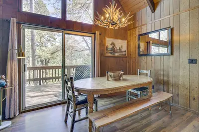 a dining room with a table and chairs and a window at Chic Lake Arrowhead Retreat 4 Seasons of Fun! in Lake Arrowhead