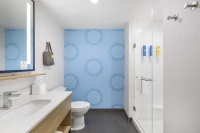 a bathroom with a toilet sink and a shower at Tru by Hilton Norco Eastvale in Norco