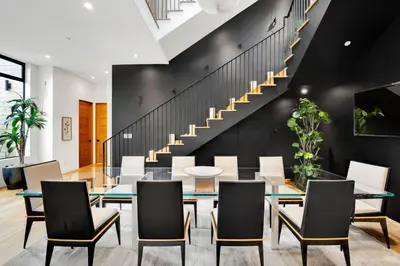 a dining room with a table and chairs and a staircase at The Bella Villa Venice Beach - luxury interior design - spa and terrace in Los Angeles