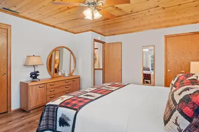 a bedroom with a bed and a ceiling fan at Big Bear Lake Sleep 16 in Big Bear Lake