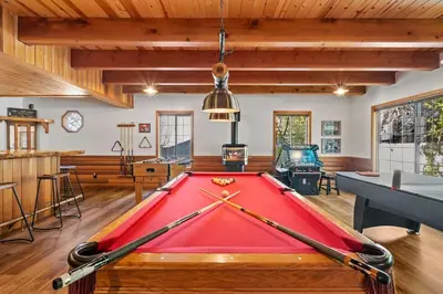 a pool table in the middle of a room at Big Bear Lake Sleep 16 in Big Bear Lake