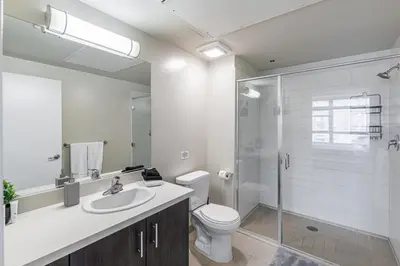 a bathroom with a toilet and a sink and a shower at 2 Bed 2 Bath X street LA Live, Convention Center, Microsoft Theater in Los Angeles