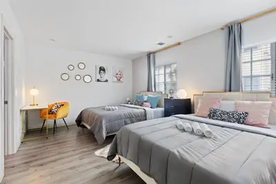 a bedroom with two beds and a desk with a chair at Luxury Oasis in Culver City! Free parking and Jacuzzi in Los Angeles