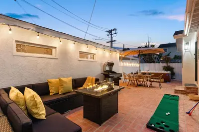 a living room with a couch and a table with a pool at Luxury Oasis in Culver City! Free parking and Jacuzzi in Los Angeles