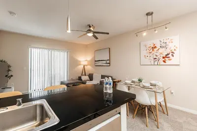 a kitchen and living room with a sink and a table at Luxury One Bedroom minutes from The Grove in Los Angeles