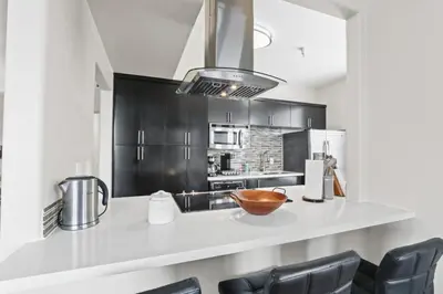 a kitchen with black cabinets and a bowl on a counter at Spacious 3-Bedroom 3BTH Apt in Marina Del Rey! Pool, Hot Tub in Los Angeles