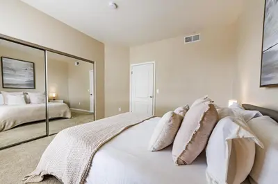 a bedroom with a bed and a large mirror at Spacious 3-Bedroom 3BTH Apt in Marina Del Rey! Pool, Hot Tub in Los Angeles